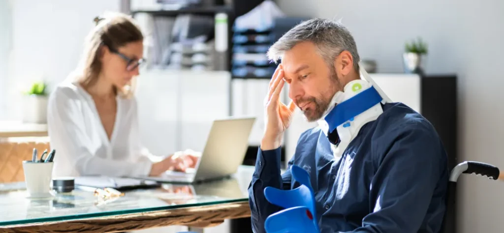 Injured worker wearing a neck brace at a clinic office